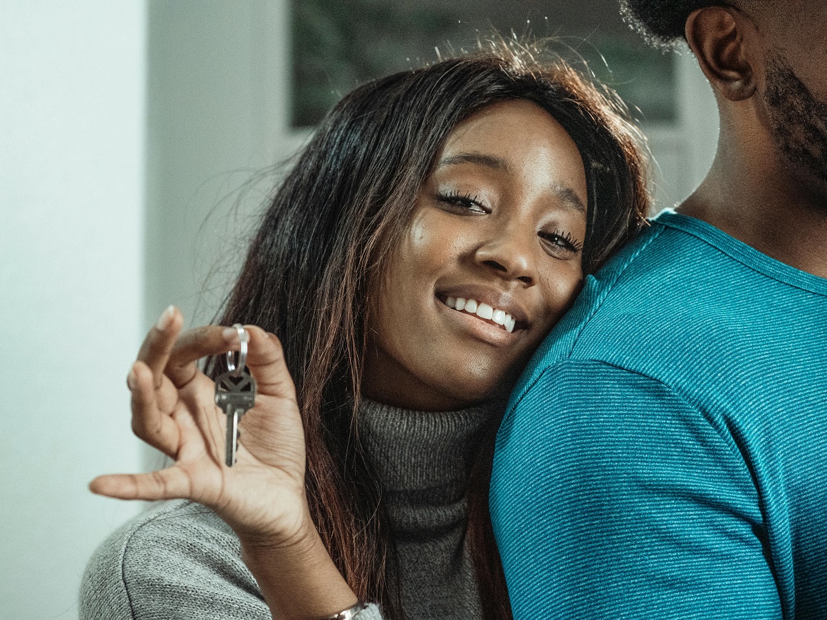 smiling woman holding a key